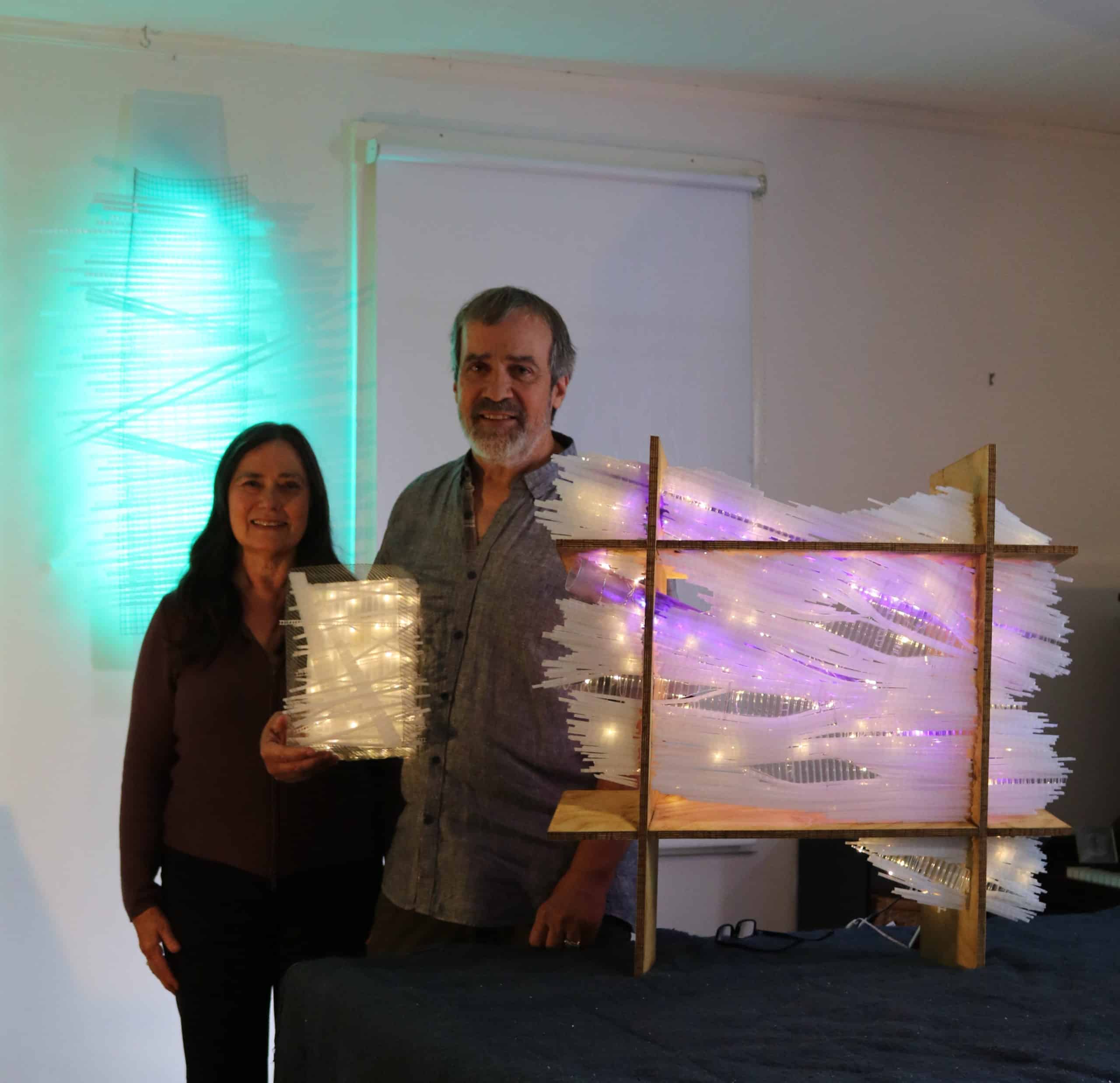 sculptor Reid Dennison and photographer Cara Sullivan stand with three Lumencrafter LED light sculptures: Box Series #1, Tectonic Ladder and Atlas of the Stars.