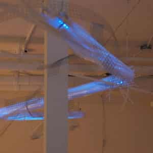 a 22 foot long jointed LED light sculpture hangs in Arcadia Art Gallery, Toronto