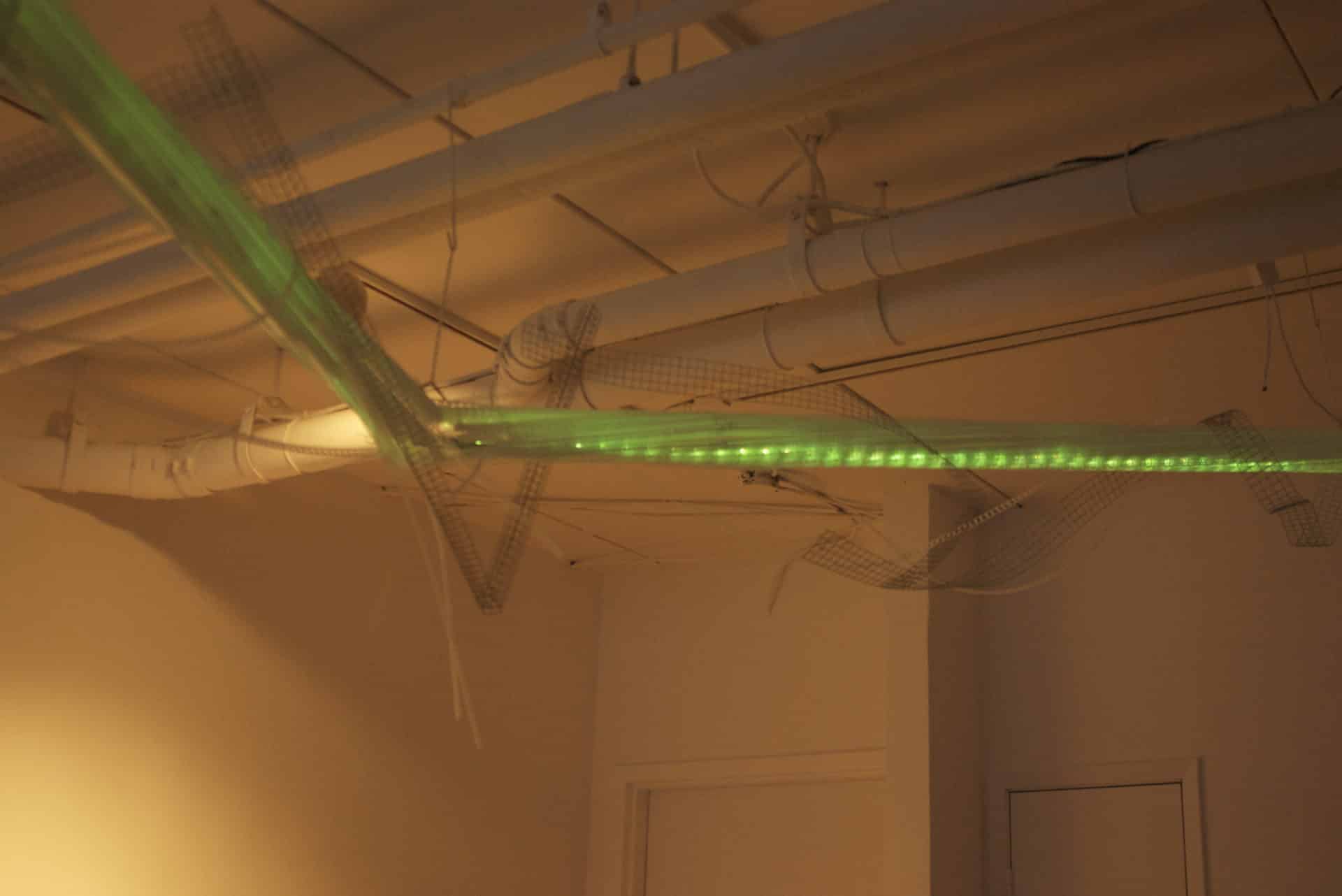 22-foot-long pendant LED light sculpture, changing colours. LED lights run through three acrylic tubes joined with heavy gauge wire, wrapped with strips of steel mesh and polycarbonate. stunning; completely original.