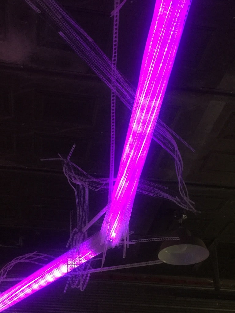 22-foot-long pendant LED light sculpture, changing colours. LED lights run through three acrylic tubes joined with heavy gauge wire, wrapped with strips of steel mesh and polycarbonate. stunning; completely original.