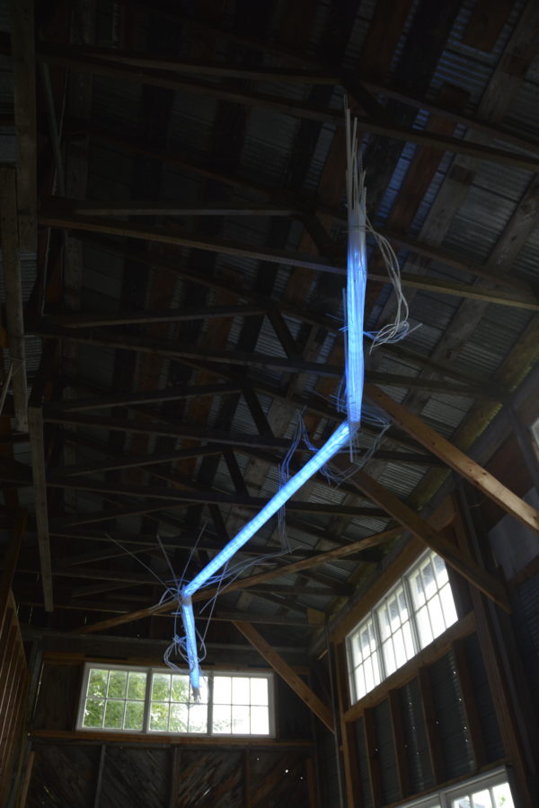 22-foot-long LED light sculpture, changing colours.  LED lights run through three acrylic tubes joined with heavy gauge wire, wrapped with strips of steel mesh and polycarbonate.  stunning; completely original.