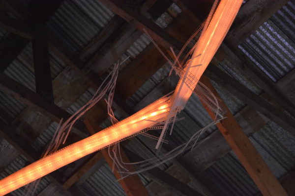 22-foot-long LED light sculpture, changing colours.  LED lights run through three acrylic tubes joined with heavy gauge wire, wrapped with strips of steel mesh and polycarbonate.  stunning; completely original.