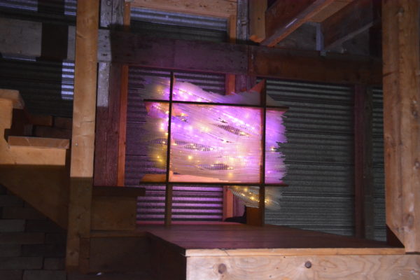 original LED light sculpture, violet-pink and white light, free-standing, slightly more than 2 feet square, glows against corrugated steel