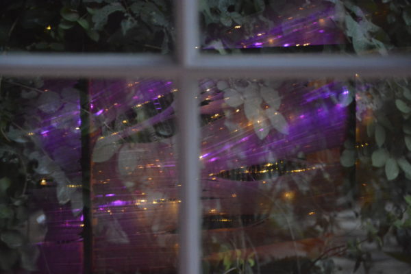 original LED light sculpture, violet-pink and white light, free-standing, slightly more than 2 feet square, reflected in window pane