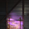 original LED light sculpture, violet-pink and white light, free-standing, slightly more than 2 feet square, glows against corrugated steel
