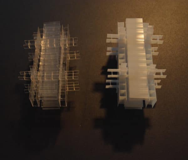 Side-by-side, clear and white inner cores of free-standing LED table light by Lumencrafter.  Light yet sturdy, 6 inches high by four inch square base. Hand-painted plates of polycarbonate enclose dew drop LEDs wrapped around an inner polycarbonate core.  Indoor/outdoor. Suitable for evening al fresco dining or bedside mood lighting. Cordless; 3 AA batteries included.