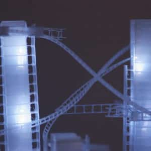 Close-up of This Years' Model, a.k.a. If You Lived Here, You'd be Home by Now, free-standing soft blue-white original handmade Lumencrafter LED light sculpture, square columns of different heights connected by swirls of laddered polycarbonate twinwall strips, glowing blue-white at Arcadia Art Gallery, Toronto, 2014.