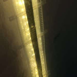 White Gold, an original LED light sculpture exhibited in the 2018 Grey County Autumn Leaves Studio Tour. A one-inch wide strip of gold runs down the centre of a slender four-foot-long structure of polycarbonate struts and spars shot through with sparkling soft-white light.