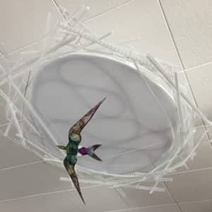 Violet-green Swallow, original LED ceiling light sculpture by Lumencrafter. Unlit shows bright colours of hand-painted bird flying below a 3-foot diameter diffusion plate, thin polycarbonate strips wound round create bird nest illusion, beautiful in day or night.