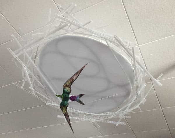 Violet-green Swallow, original LED ceiling light sculpture by Lumencrafter. Unlit shows bright colours of hand-painted bird flying below a 3-foot diameter diffusion plate, thin polycarbonate strips wound round create bird nest illusion, beautiful in day or night.