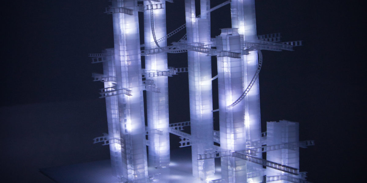 This Years' Model, a.k.a If You Lived Here, You'd be Home by Now, free-standing soft white original handmade Lumencrafter LED light sculpture, square columns of different heights connected by swirls of laddered polycarbonate twinwall strips, glowing blue-white at Arcadia Art Gallery, Toronto, 2014.