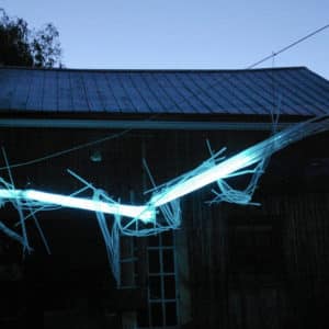 A Roar, A Boar y Alice, a 22-foot-long LED light sculpture glowing blue in the dark at the 2016 Local Colour Art Garden, Flesherton. LED lights run through three acrylic tubes joined with heavy gauge wire, wrapped with strips of steel mesh and polycarbonate. stunning; completely original.