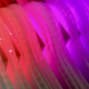 Close-up of Weight of Beauty, magenta-pink handmade LED wall sconce light sculpture by Lumencrafter hung at Sourceworks Ceramics Studio for the 2018 Grey County Autumn Leaves Studio Tour.